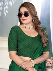 Woman wearing a green saree with a blurred background