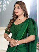 Load image into Gallery viewer, Woman wearing a green saree with a blurred background